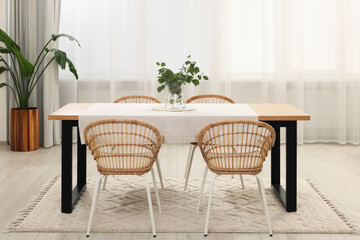 Stylish dining room with cozy furniture and plants
