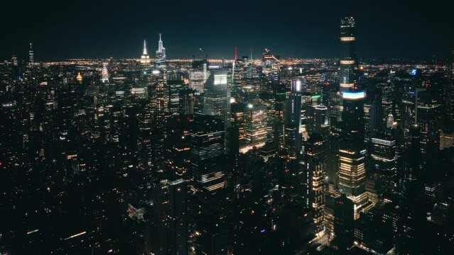 Tremendous night city lights scenery top view. Business offices in skyscrapers after dark. Breathtaking New York city views from above, USA 4K aerial. Immense New York panorama at night time