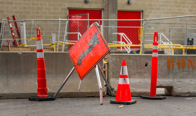 construction cone, standing alone on a sunlit urban street, symbolizing safety, roadwork, caution,...