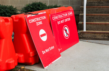 construction cone, standing alone on a sunlit urban street, symbolizing safety, roadwork, caution,...