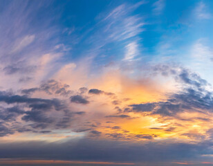 Naklejka na ściany i meble Beautiful panoramic sky with glowing clouds at sunset