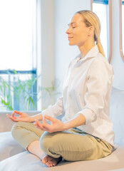 caucasian woman meditating at home