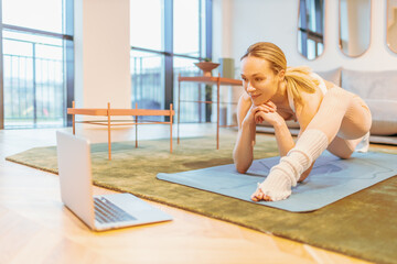 caucasian woman attending online yoga lesson