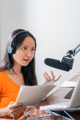 Female podcast making audio podcast from her home studio