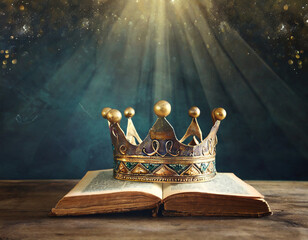 low key image of beautiful queen or king crown over antique book. vintage filtered. fantasy medieval period - obrazy, fototapety, plakaty