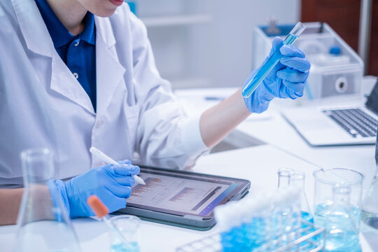 Woman scientist person research writing document science study datum in modern laboratory, professional female doctor working on medical test lab note report health technology development analysis