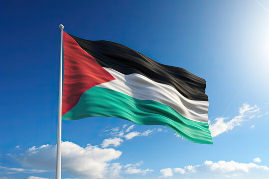 palestine flag flying high against a blue sky