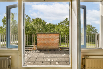 an open window with a brick wall in the middle and blue sky above it, as seen from inside outside