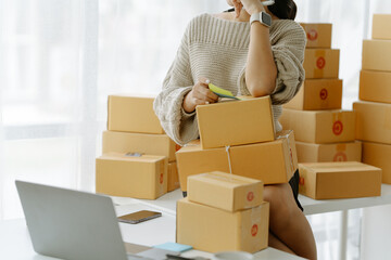 Small start-up business owners checking parcels at work, salespeople, checking production orders....