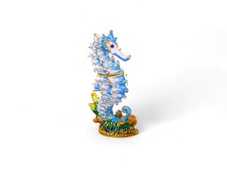 decorative statue of a blue and white seahorse animal decorated with ornaments on a white background