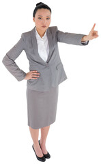 Digital png photo of serious asian businessman pointing finger on transparent background