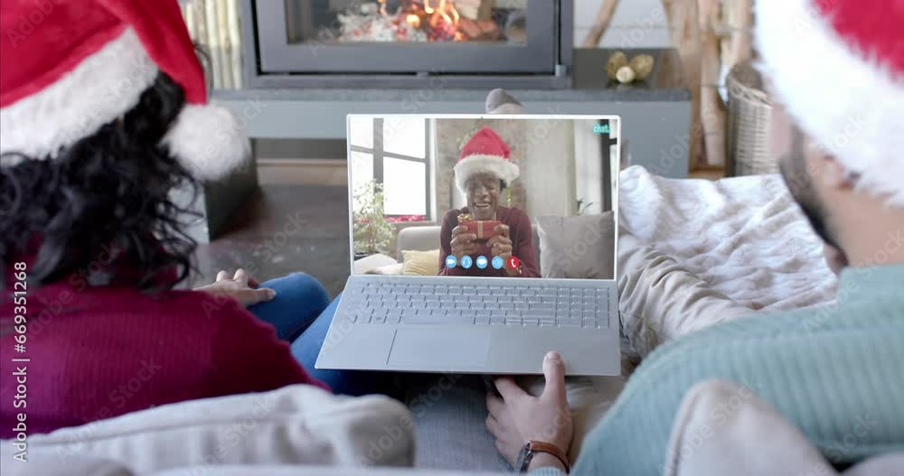 Sticker Happy diverse couple and male friend having christmas laptop video call, slow motion