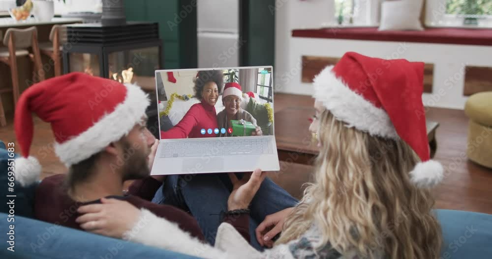 Poster Happy diverse couple, mother and daughter having christmas laptop video call, slow motion