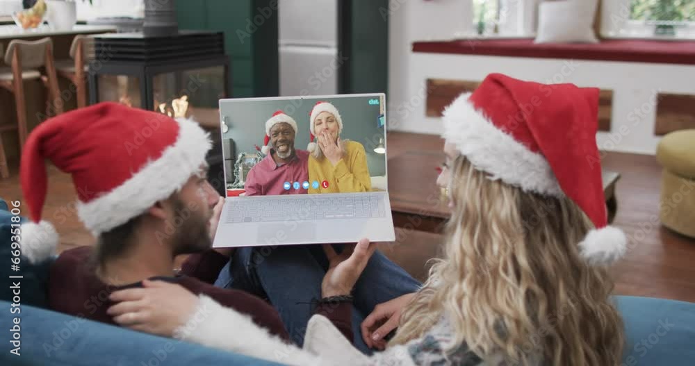 Poster Two happy diverse couples having christmas laptop video call, slow motion