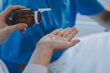 Women Asian doctors hold the patient hand and encourage and provide medical advice While checking...