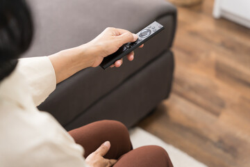 Elderly woman Watching smart TV and using remote controller Hand