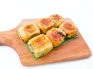 banana choco. bread that has a crispy layer of skin. Banana balls. Cake with banana and chocolate filling in board on gray  background