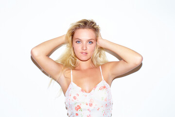 Fototapeta premium Portrait, fashion and a woman in a dress on a white background isolated in studio for trendy style. Aesthetic, beauty and hair with a confident young blonde person in a clothes outfit for summer