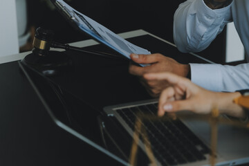 Judge gavel with Justice lawyers having team meeting at law firm in background. Concepts of law.