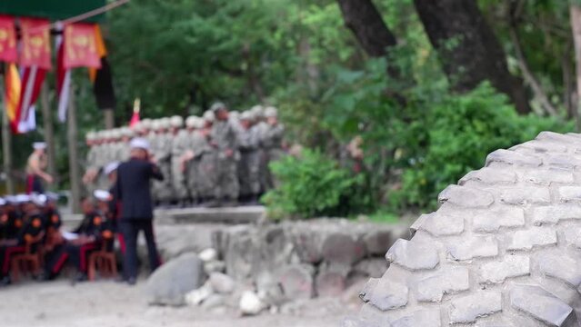 Marine soldiers aspired to upgrade promotion on standing formation to receive a graduation certificate diploma. Truck tire obscure view. blurs