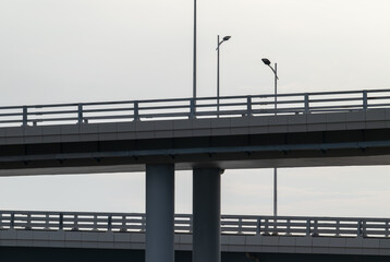 Fototapeta na wymiar silhouette of road lamps on the bridge