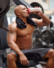 Man in gym, bodybuilder and drinking shake for fitness, training exercise and strong body with...