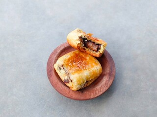 muffins with raisins. banana choco.  bread that has a crispy layer of skin. Banana balls. Cake with banana and chocolate filling on wooden bowl on gray background