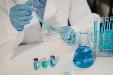 Female scientist researcher conducting an experiment working in the chemical laboratory.