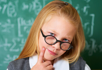 Portrait of student, nerd and kid thinking by chalkboard in class for learning knowledge, education...