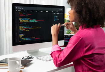 African American woman's programing developer. Coding Software project on computer screen server at...