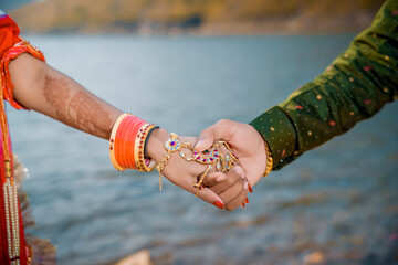 Indian married couple's holding hands close up
