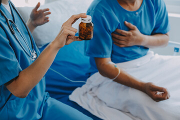 Women Asian doctors hold the patient hand and encourage and provide medical advice While checking...