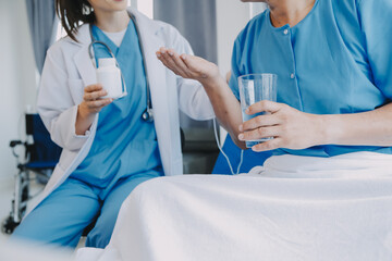 Women Asian doctors hold the patient hand and encourage and provide medical advice While checking...