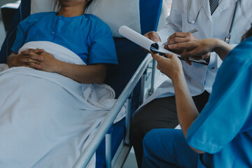 Women Asian doctors hold the patient hand and encourage and provide medical advice While checking...