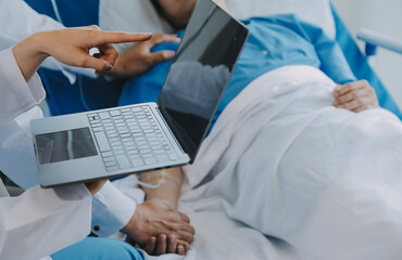 Women Asian doctors hold the patient hand and encourage and provide medical advice While checking...