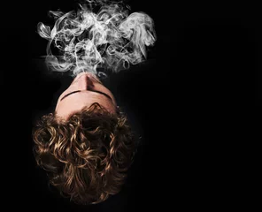 Foto op Aluminium Man smoking marijuana, drugs or cigarette in studio isolated on black background mockup. Smoke, vape and person exhale cannabis, weed and addiction to tobacco, 420 cbd or substance abuse in top view © Nicola Katie/peopleimages.com