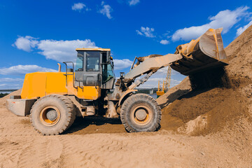 Yellow Excavator working on sand industrial quarry. Construction site industry concept