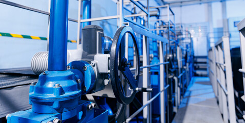 Banner industry waterworks. Closeup valve of blue taps for drinking water pipeline for city service - obrazy, fototapety, plakaty
