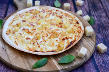 Italian roman   style  cheese pizza with parmesan cheese,  ham,  mushrooms and tomato sauce 