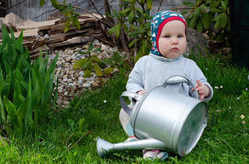 baby with watering can