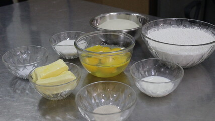 Ingredients for baking cakes on stainless steel table side view background