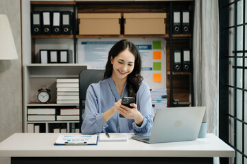 Asian business woman have the joy of talking on the smartphone, tablet and laptop video call on the modern office