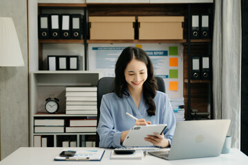 Asian business woman have the joy of talking on the smartphone, tablet and laptop video call on the modern office