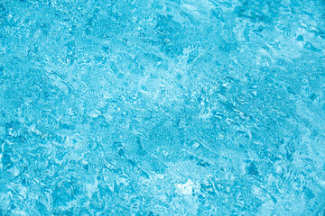 Fototapeta na wymiar Blue ripped water in swimming pool, water pool texture and surface water backgraund.