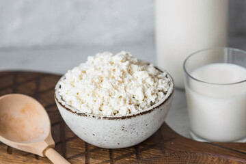 Fresh dairy products, milk, cottage cheese, eggs in stylish ceramic dishes on a gray background. The concept of natural, dietary nutrition. Useful products.