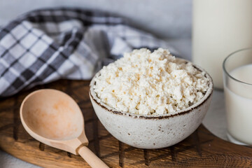 Fresh dairy products, milk, cottage cheese, eggs in stylish ceramic dishes on a gray background. The concept of natural, dietary nutrition. Useful products.