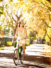 Bicycle, woman and cycling for wellness or health, vacation and central park as eco friendly city...