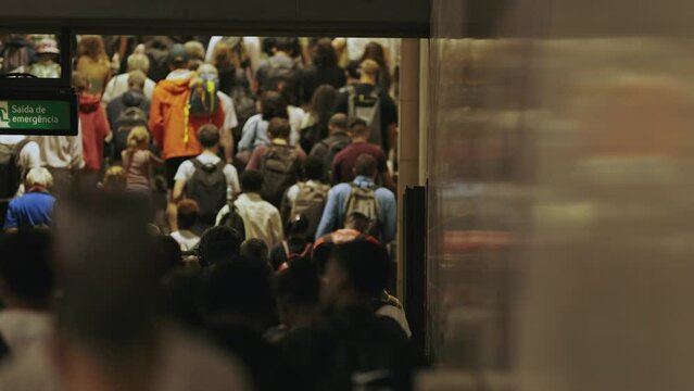 A crowd passengers walking to the exit in metro undeground
