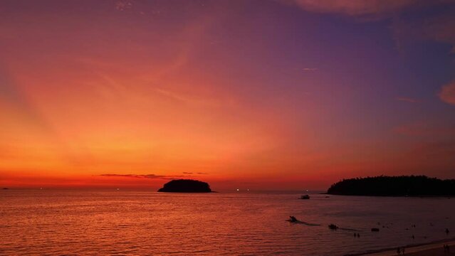 Aerial view exotic red sky in twilight above the island at Kata beach Phuket..Scene of Colorful romantic red sky..beautiful red sky at sunset nature and travel concept..gradient color. sky texture.