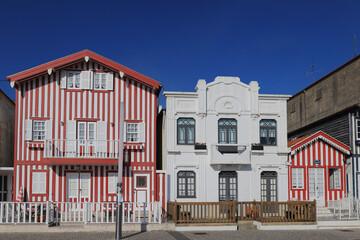 Street with colorful houses. Street with striped houses, Costa Nova, Aveiro, Portugal. Facades of...